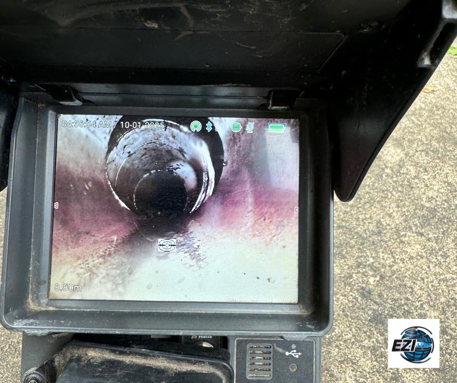 Technician inspecting blocked drain with CCTV camera